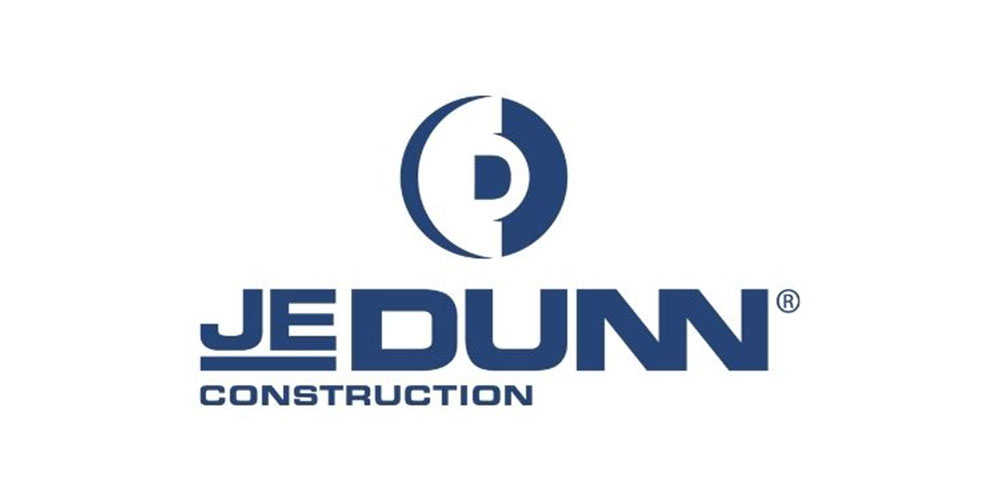 JE Dunn Construction logo featuring a stylized "D" emblem above the company's name in bold blue letters on a white background.